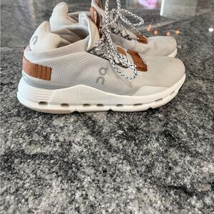 On Running Cream and Brown Athletic Shoes